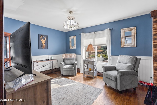 living area featuring hardwood / wood-style floors and a notable chandelier