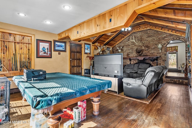 game room featuring brick wall, billiards, a fireplace, hardwood / wood-style floors, and vaulted ceiling with beams