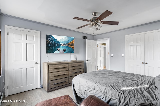 bedroom with light wood-type flooring, ceiling fan, and ornamental molding