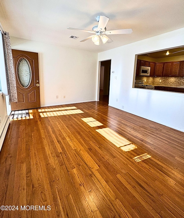 unfurnished living room featuring wood-type flooring and ceiling fan