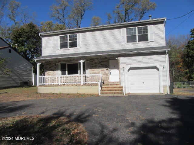 view of front property with a garage and covered porch