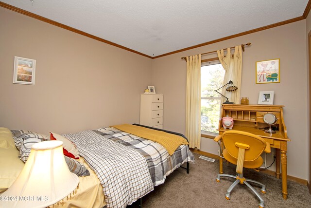 bedroom with a textured ceiling, carpet floors, and ornamental molding