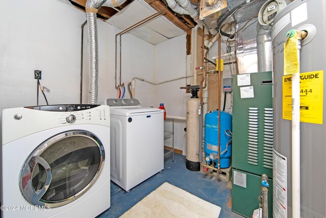 laundry area with water heater and independent washer and dryer