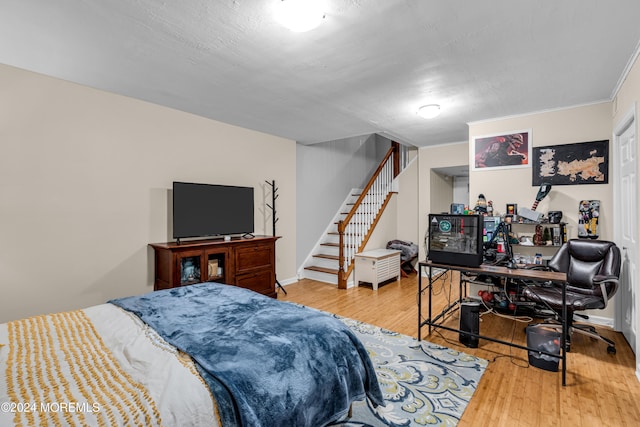 bedroom featuring wood-type flooring and a textured ceiling