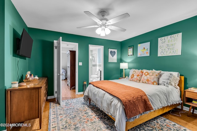 bedroom featuring ceiling fan, light wood-type flooring, and ensuite bathroom