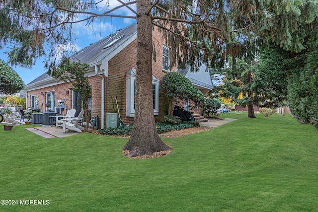 view of property exterior with a patio, cooling unit, and a lawn