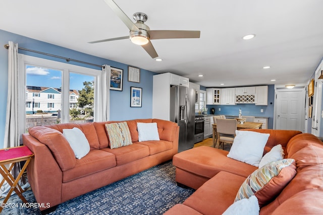 living room featuring sink and ceiling fan