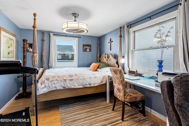 bedroom with wood-type flooring and built in desk