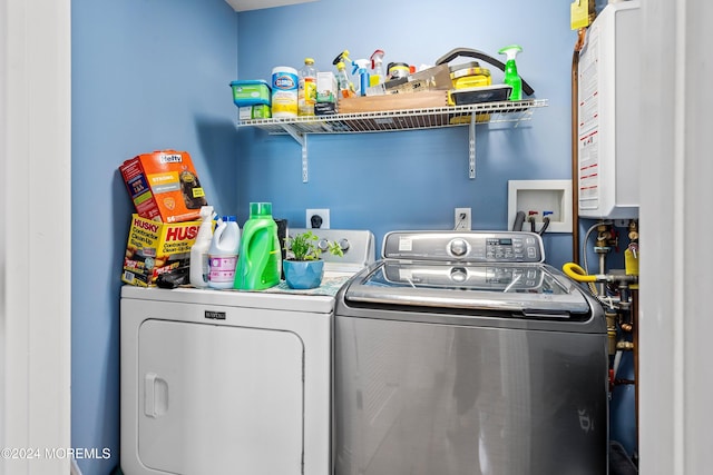 washroom featuring water heater and washer and dryer