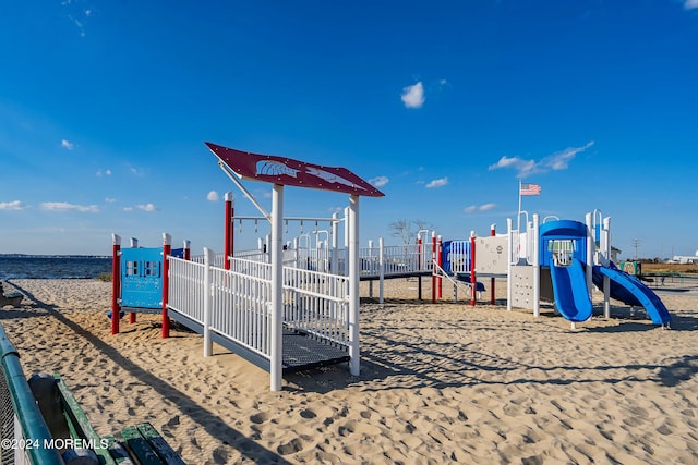 view of playground with a water view