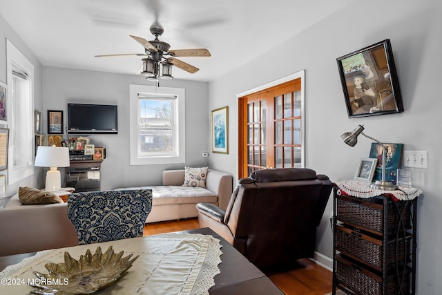 living room featuring hardwood / wood-style flooring and ceiling fan