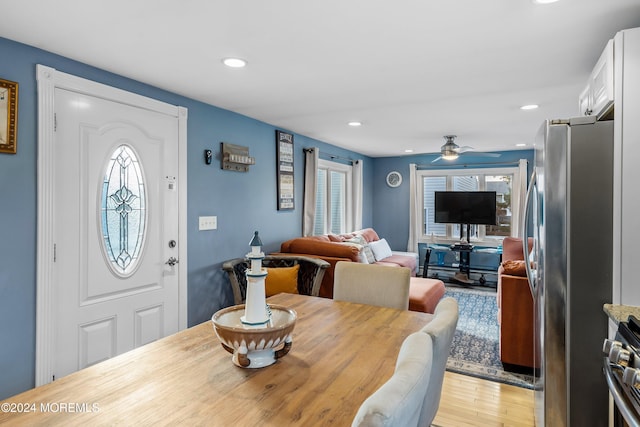 dining room featuring ceiling fan, plenty of natural light, and light hardwood / wood-style floors