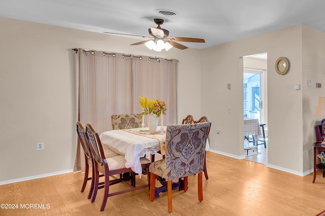 dining room with ceiling fan and light hardwood / wood-style flooring