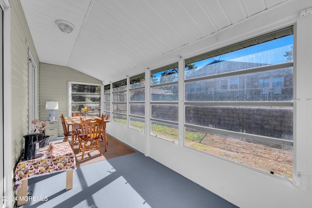 sunroom / solarium featuring vaulted ceiling