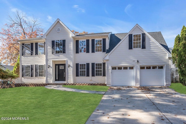 view of front of home with a front yard and a garage