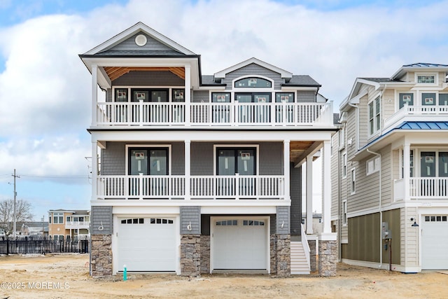 raised beach house featuring stone siding and a garage