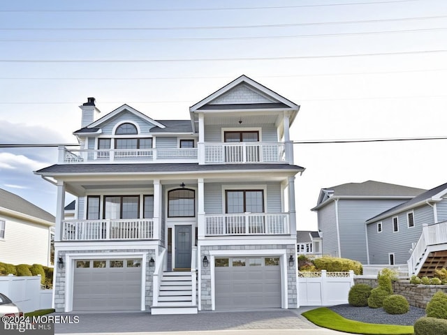 raised beach house with a garage and a balcony