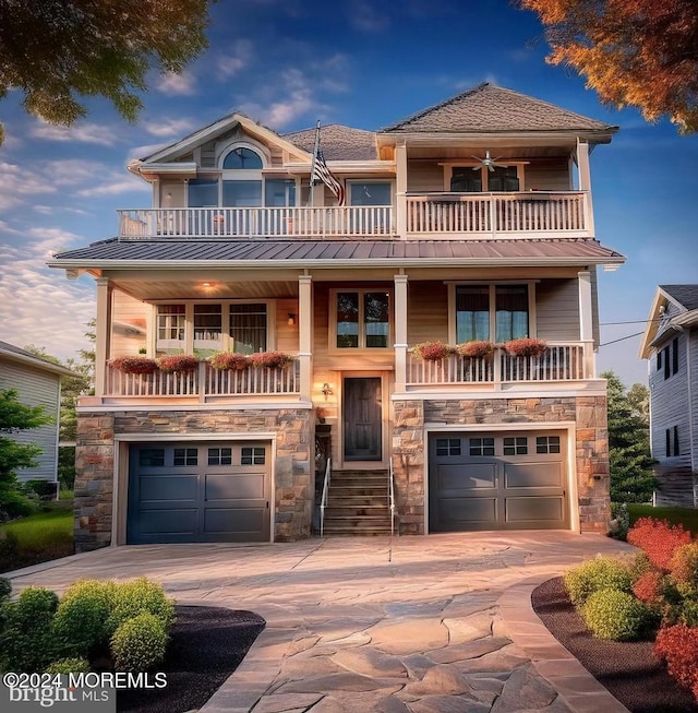 view of front of property with a balcony and a garage