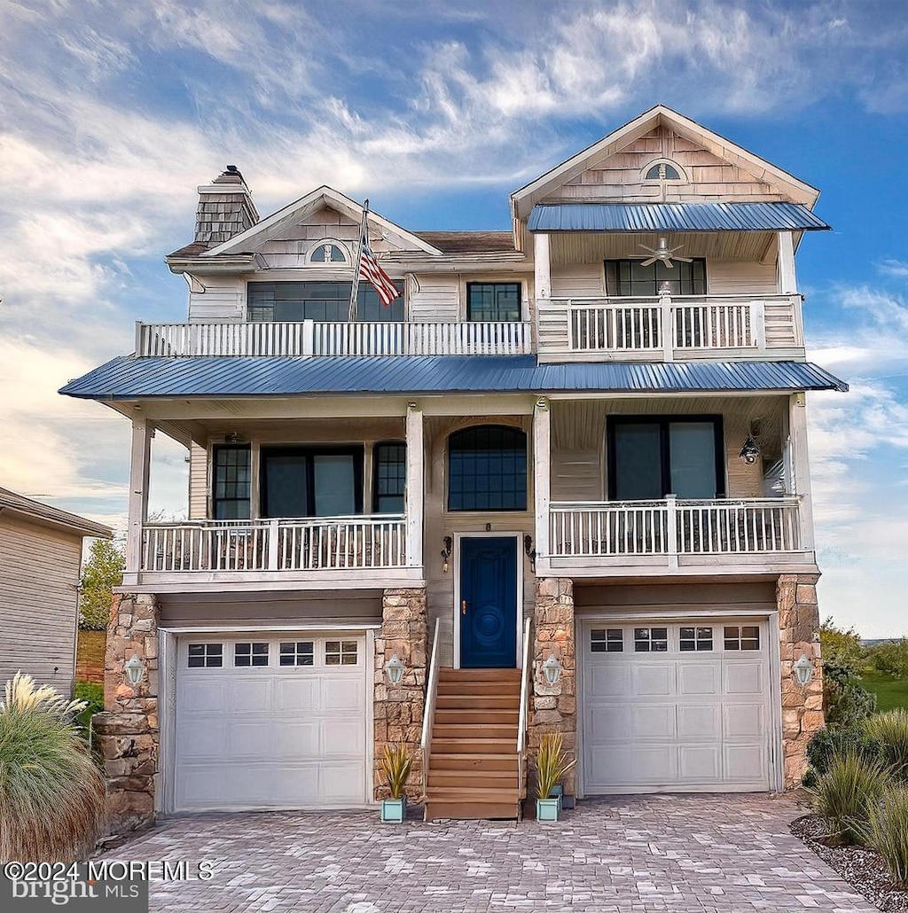 view of front facade with a balcony and a garage