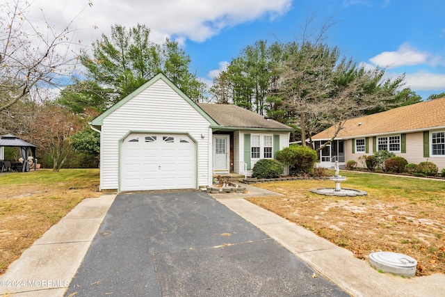 ranch-style home featuring a gazebo, a garage, and a front lawn