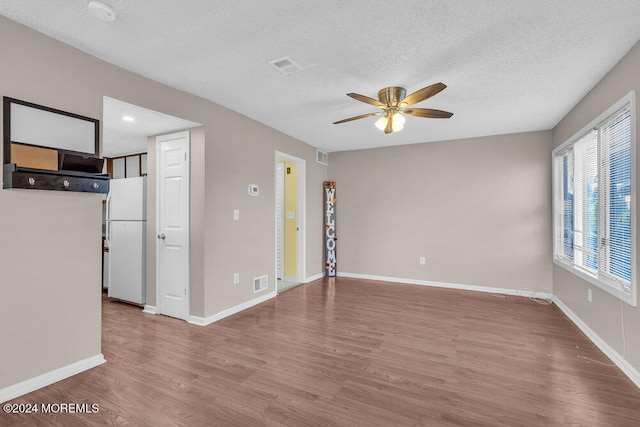 interior space with hardwood / wood-style flooring, ceiling fan, and a textured ceiling