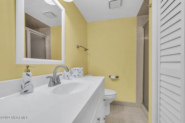 bathroom featuring vanity, tile patterned flooring, toilet, and an enclosed shower