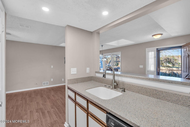 kitchen featuring light hardwood / wood-style floors, plenty of natural light, sink, and white cabinetry