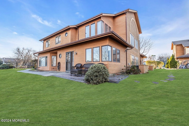 rear view of house featuring a patio and a yard