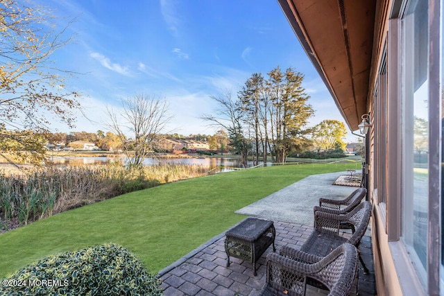 view of yard with a water view and a patio area