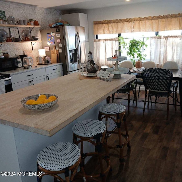 dining room with dark hardwood / wood-style flooring