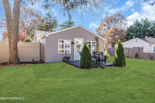 rear view of house with a lawn and a patio area