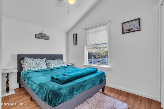 bedroom featuring ceiling fan, wood-type flooring, and vaulted ceiling