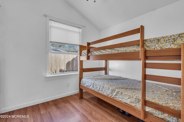 bedroom featuring lofted ceiling and hardwood / wood-style flooring