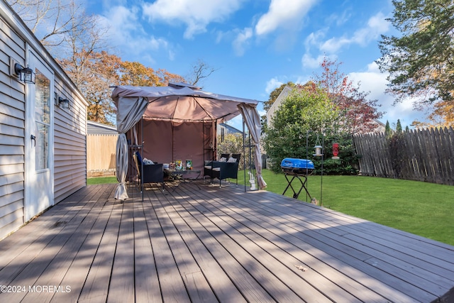 deck featuring a lawn and a gazebo