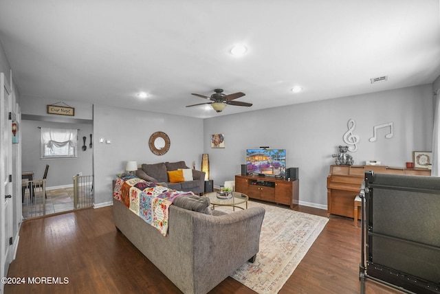 living room with dark wood-type flooring and ceiling fan