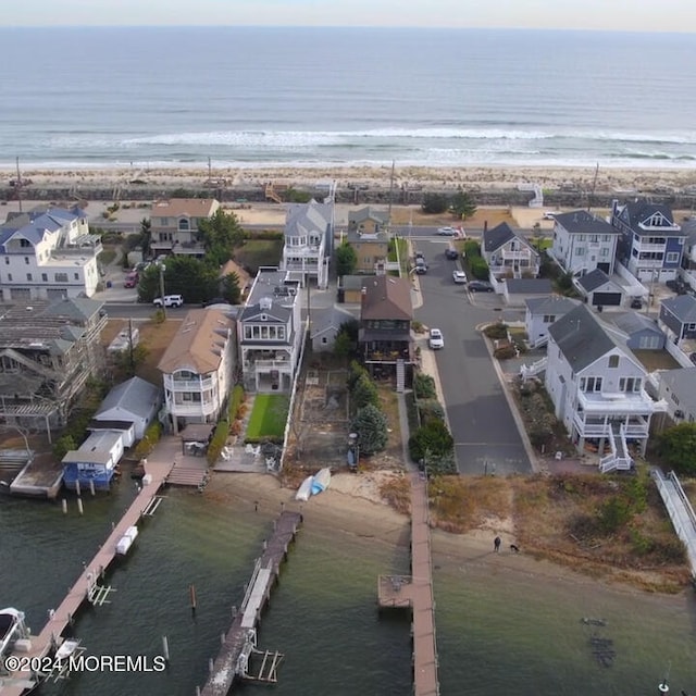 aerial view with a water view and a beach view