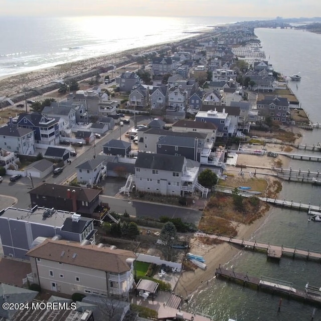 bird's eye view with a water view and a beach view