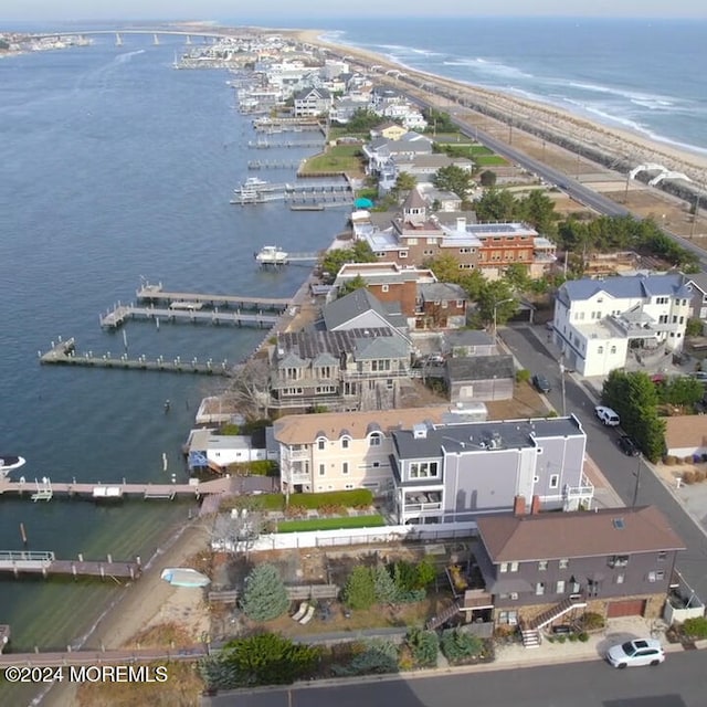 birds eye view of property featuring a water view and a view of the beach