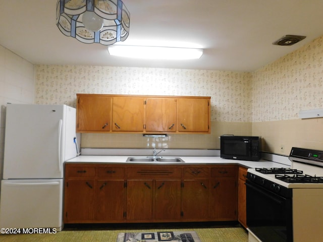 kitchen with sink and white appliances