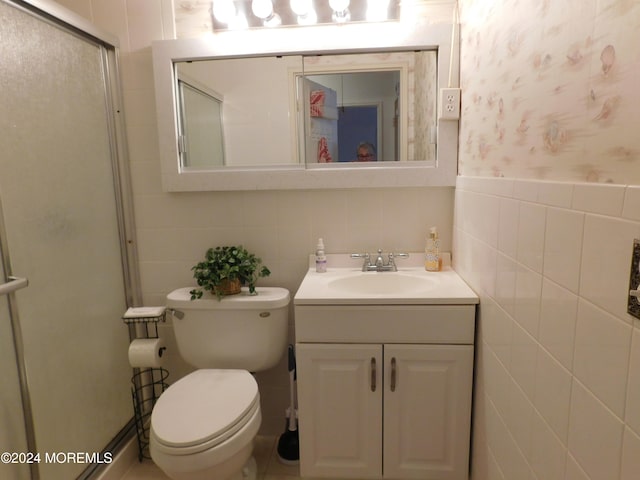 bathroom with vanity and tile walls