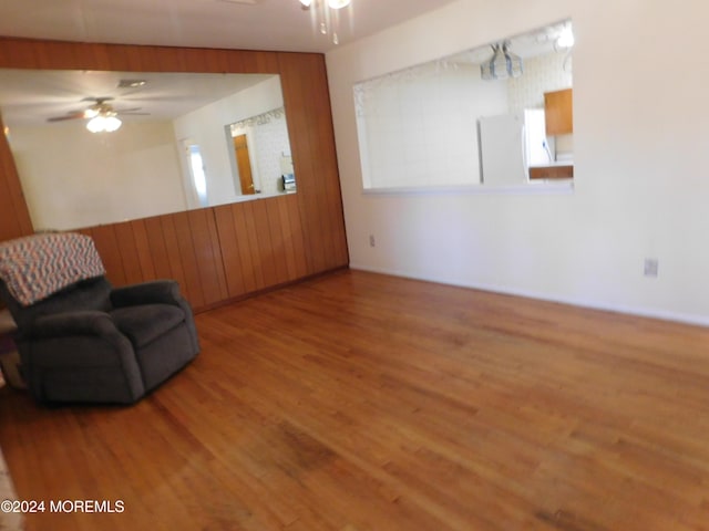 sitting room with wood-type flooring and ceiling fan