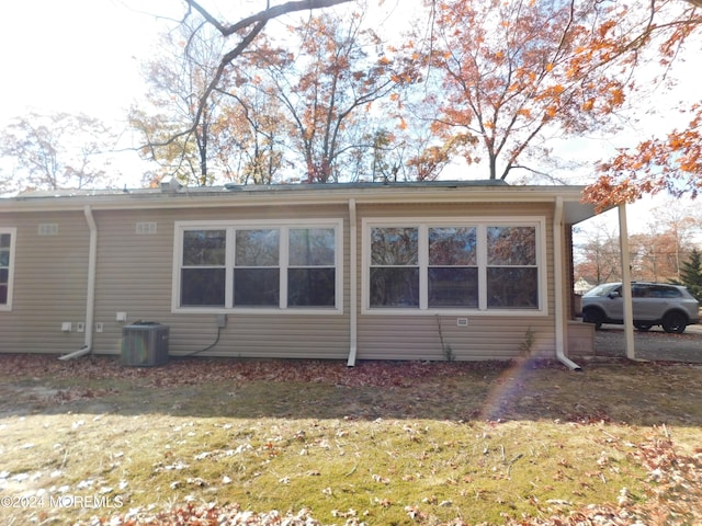 view of side of home with central AC