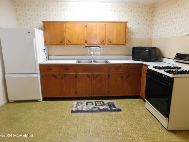 kitchen with sink and white appliances