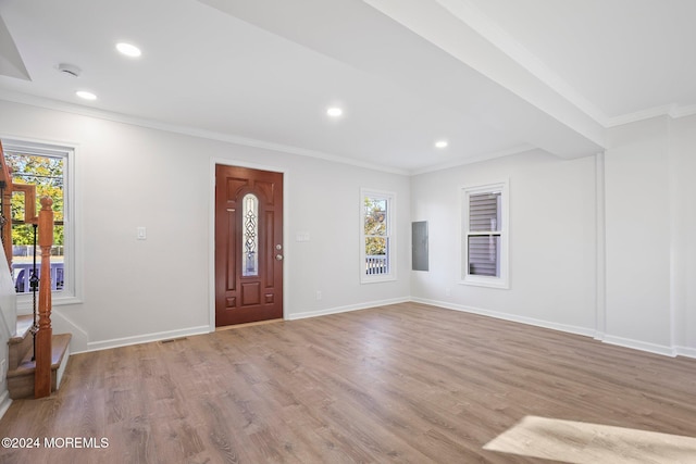 foyer entrance featuring ornamental molding and light wood-type flooring