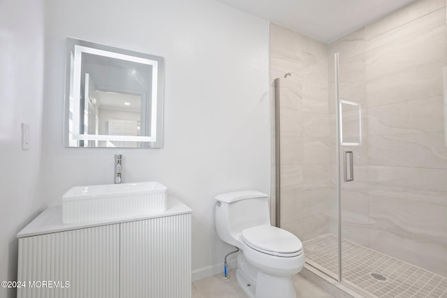 bathroom featuring vanity, toilet, and a shower with door