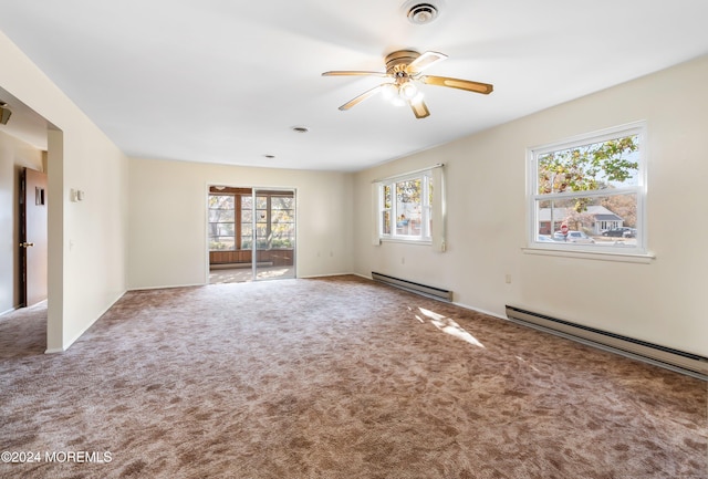 carpeted spare room featuring a baseboard radiator, ceiling fan, and plenty of natural light