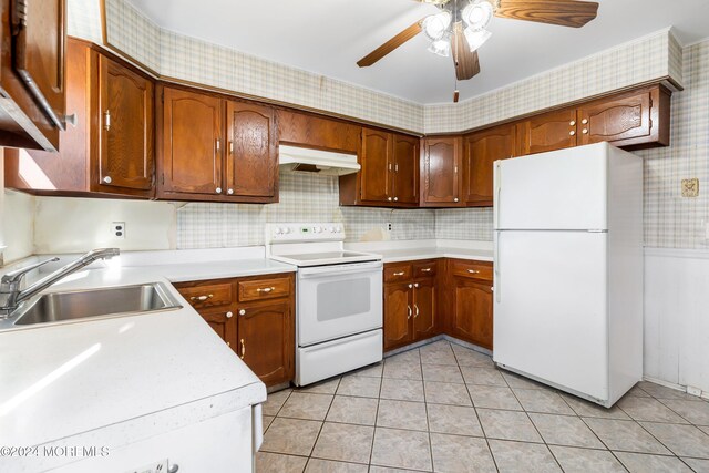 kitchen with light tile patterned flooring, white appliances, sink, and ceiling fan