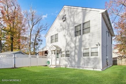 rear view of house with a lawn