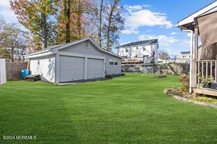 view of yard with a garage and an outdoor structure