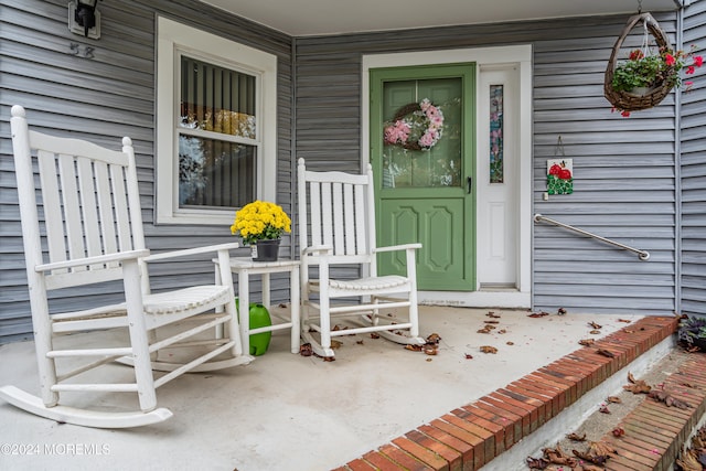 view of exterior entry with a porch